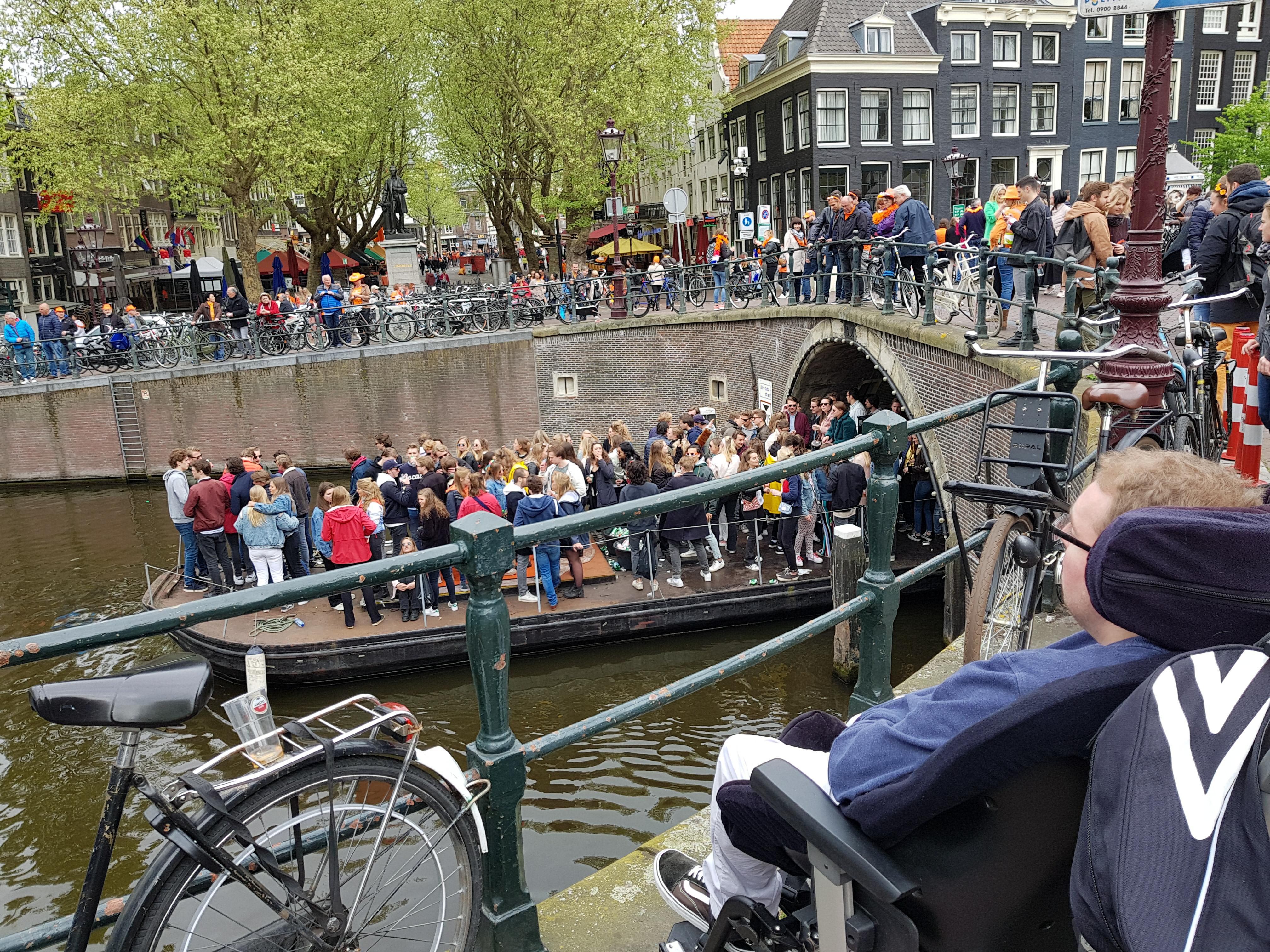 A boat on one of Amsterdam's canals filled with people partying