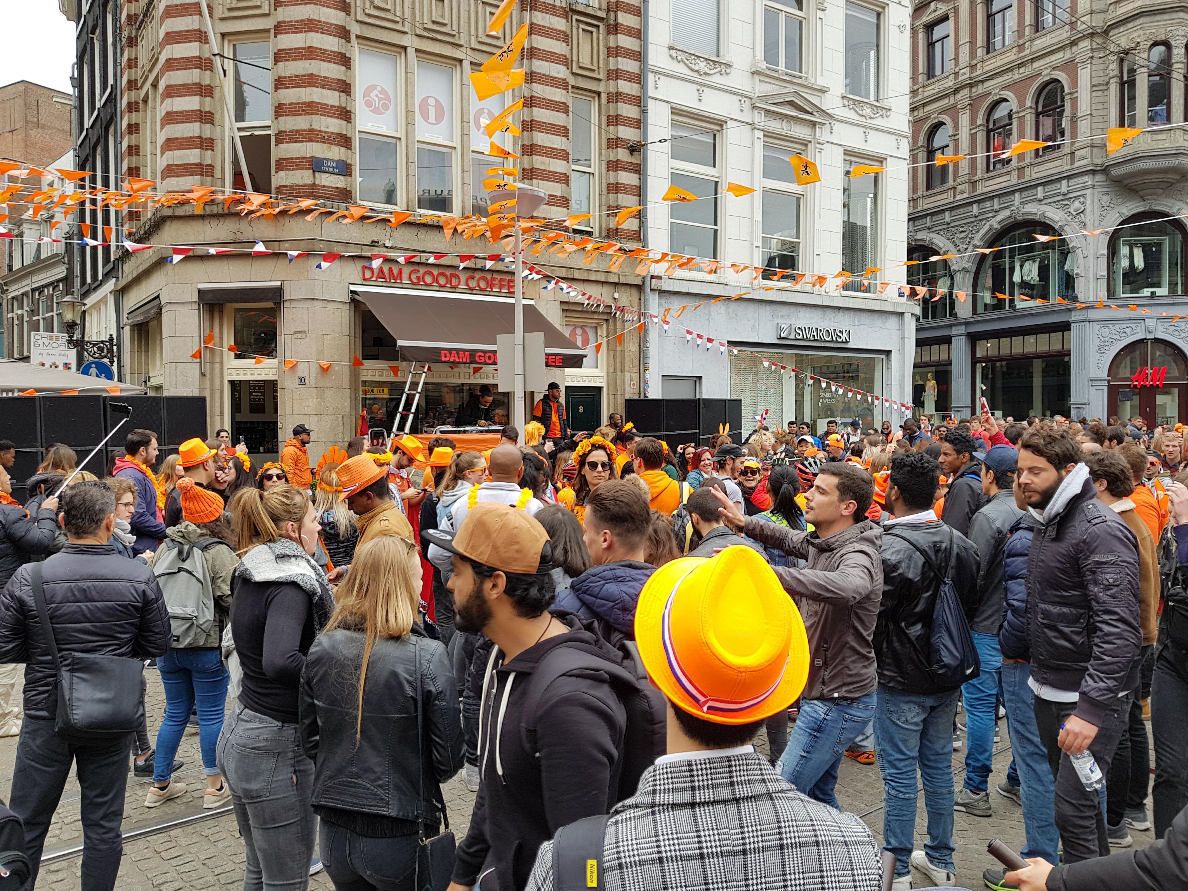 A party in Amsterdam's dam square with lots of people partying