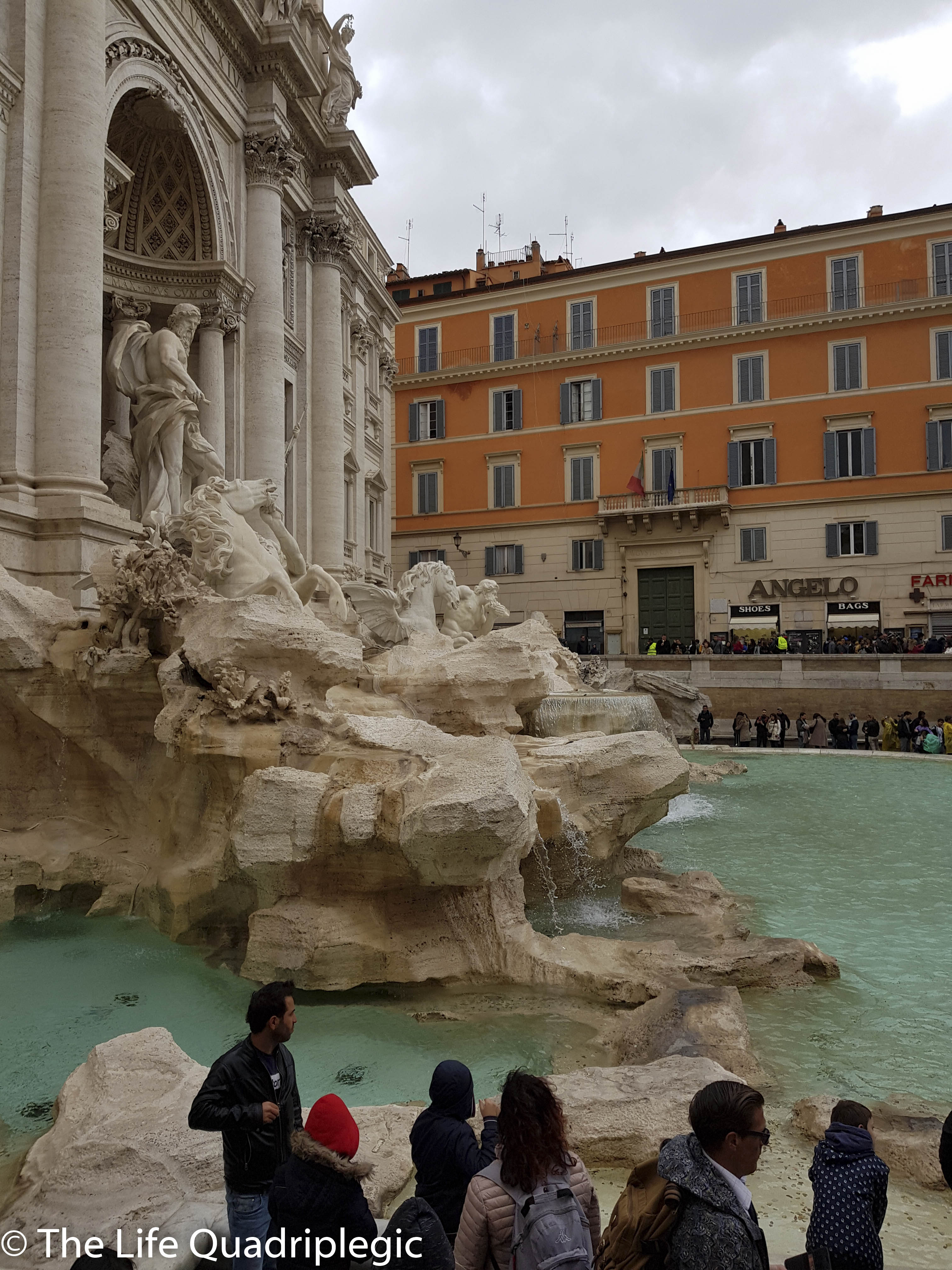 The Trevi Fountain in Rome, showcasing intricate sculptures and flowing water, surrounded by spectators admiring its beauty.