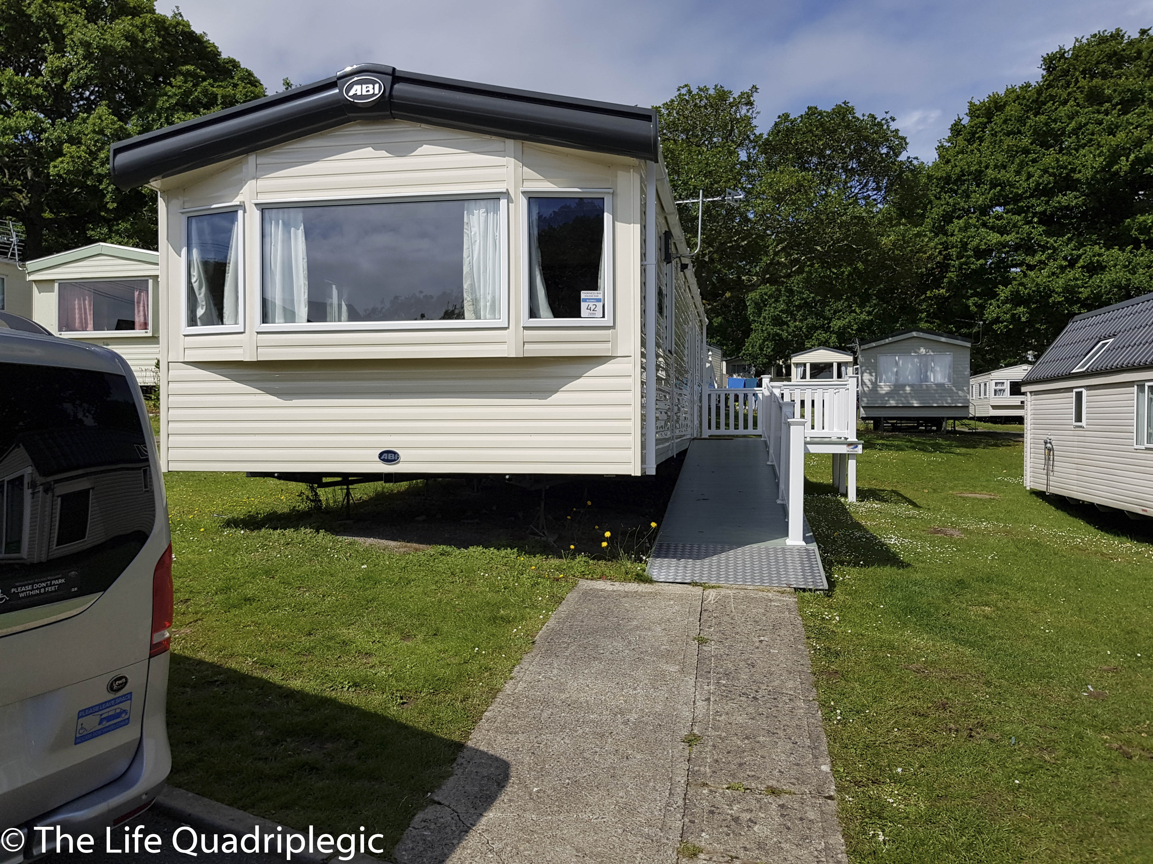 Wheelchair accessible static caravan at Thorness Bay Holiday Park, showing a ramp leading to the entrance.