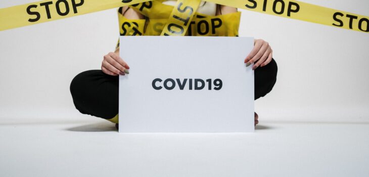 person holding covid sign