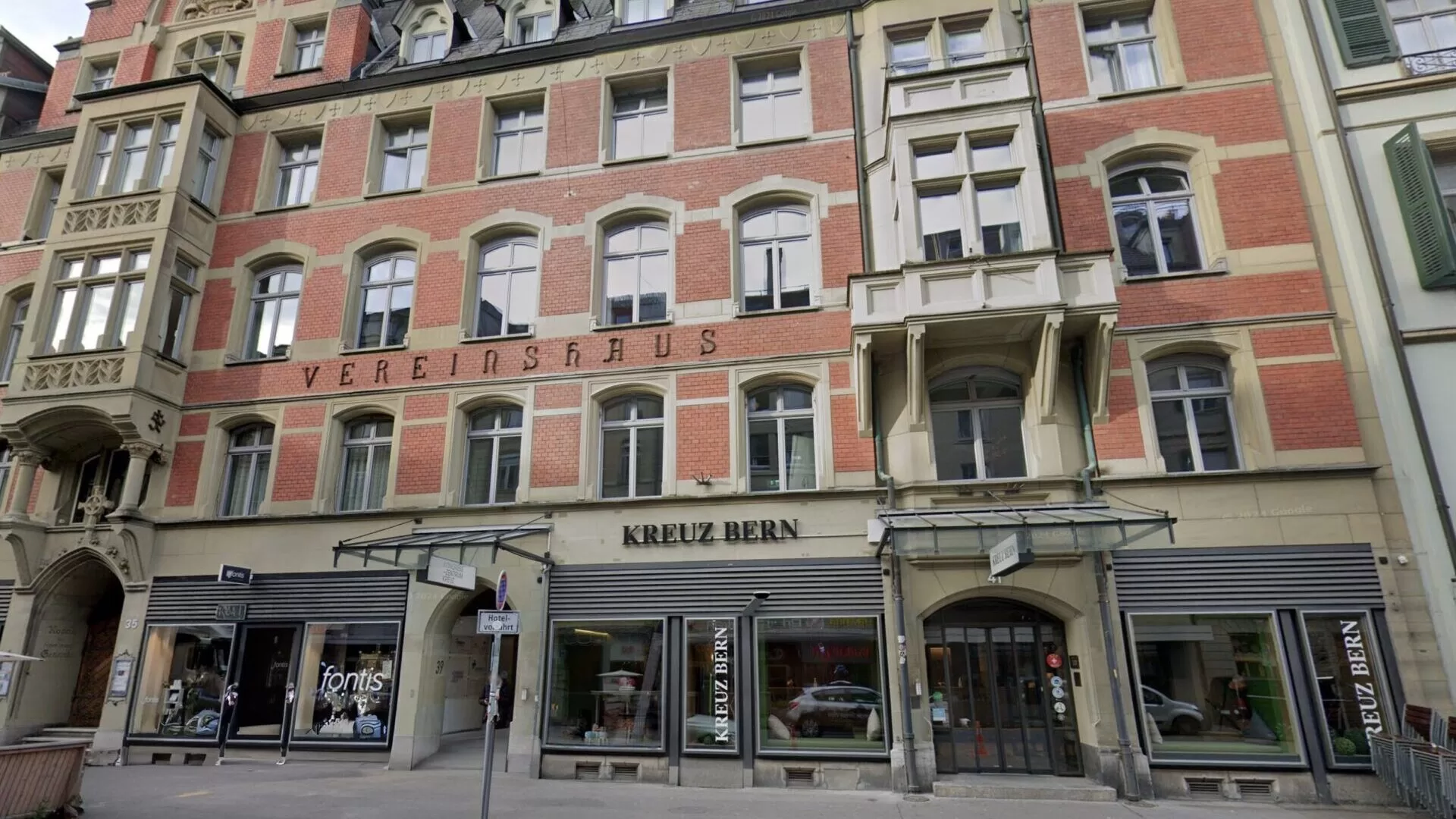Front view of the Hotel Kreuz Bern, showcasing its architectural features and signage.