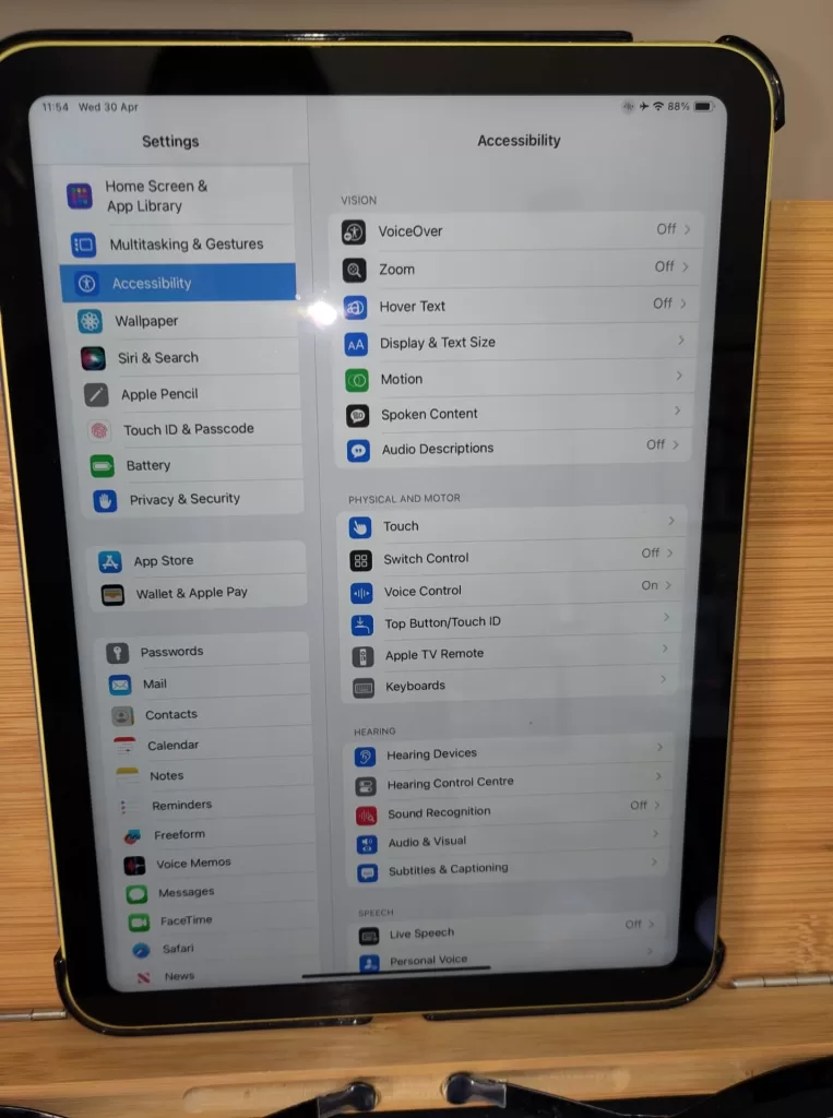 iPad displaying the Accessibility settings page, showcasing various accessibility options for vision, physical and motor, hearing, and speech.