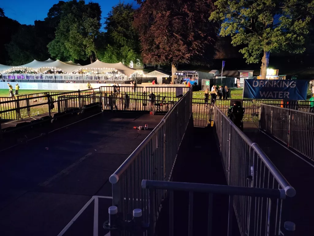 View of the accessible viewing platform at Lincoln Castle Live, featuring barriers, ramps, and a sign indicating drinking water.