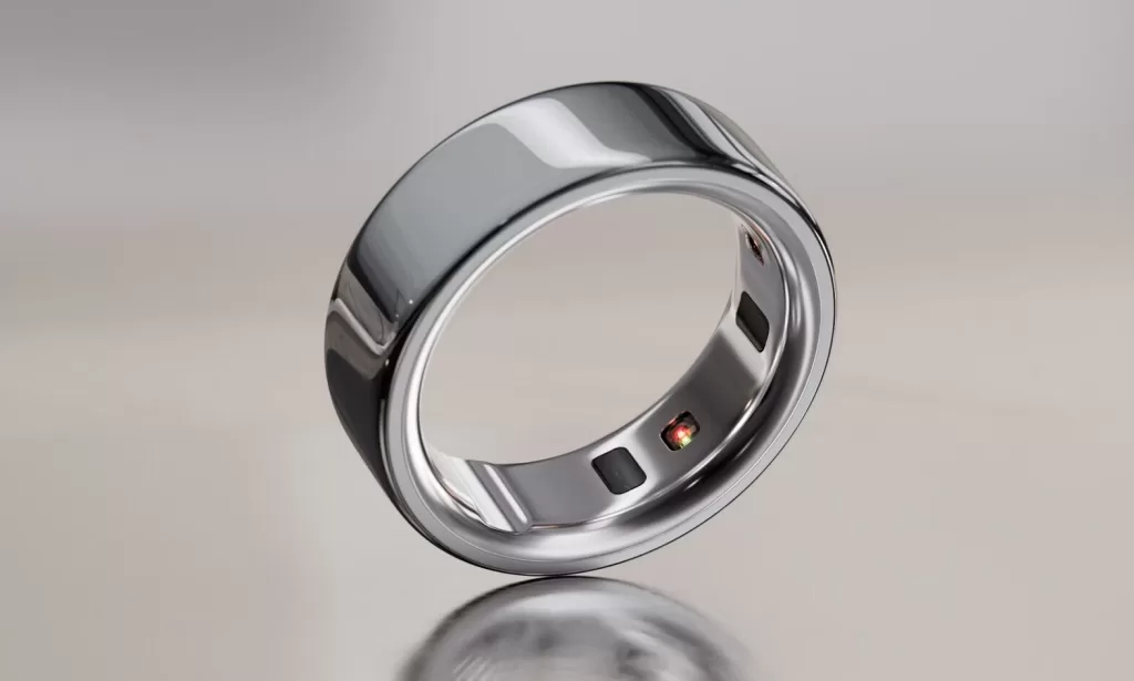 A close-up of the Oura Ring 4, a sleek, metallic health tracker designed to resemble a standard ring with embedded sensors.