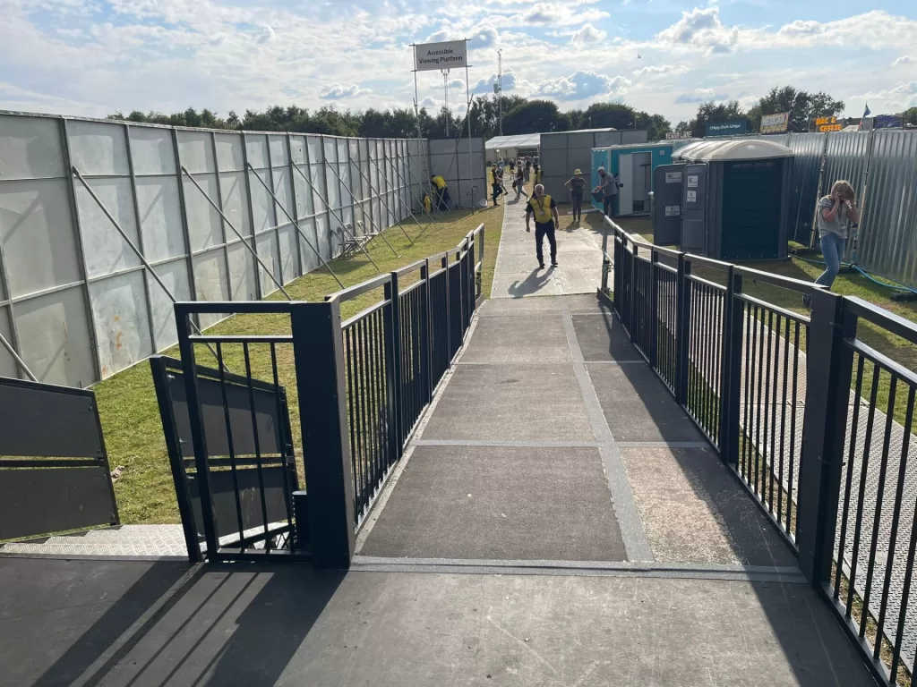 Accessible viewing platform entrance with smooth walkway and railing.